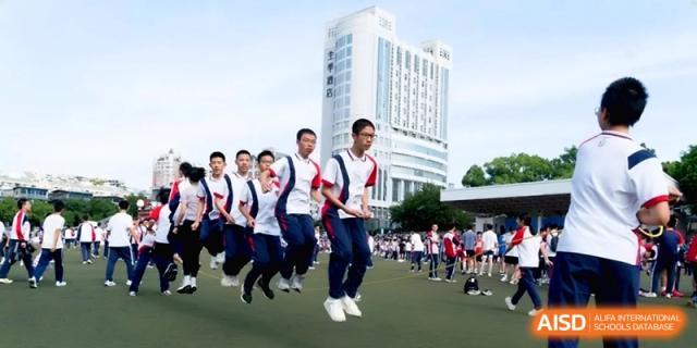A group of students jump in unison during a physical education drill at the Affiliated High School of Fujian Normal University.