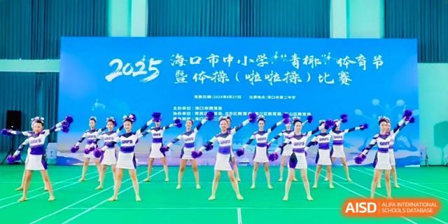 The school cheerleading squad performing a synchronized routine on a green mat at the Affiliated High School Of Peking University Haikou.