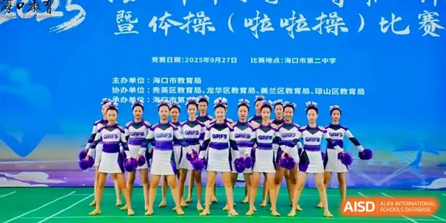 Members of the cheerleading team standing in formation for a group photo at the Affiliated High School Of Peking University Haikou.