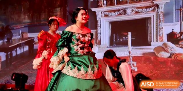 A student dressed in an elaborate green Victorian-style gown participates in a theatrical play or costume showcase at Baoji Nanshan High School.