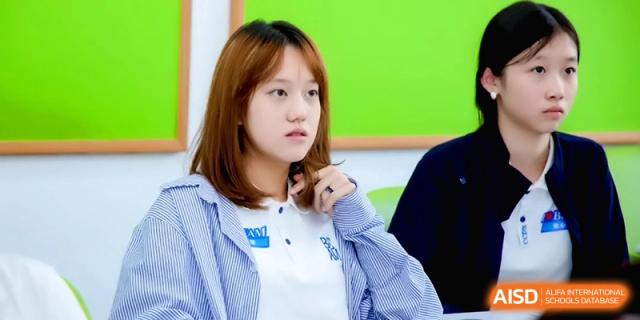 A close-up of a female student looking thoughtfully toward the front of the class at Beijing Eastbank Academy of Music.