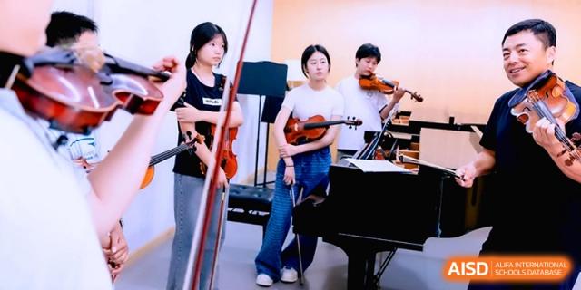 Three young musicians holding violins while standing next to a grand piano during a practice session at Beijing Eastbank Academy of Music.