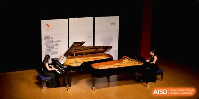 Two grand pianos positioned on a wooden stage for a professional recital at Beijing Eastbank Academy of Music.