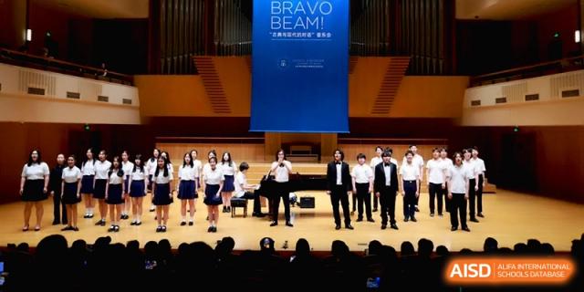 A large group of students and performers on stage for the Bravo Beam concert at Beijing Eastbank Academy of Music.