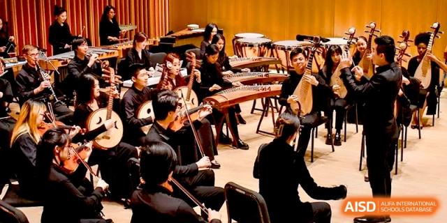 A traditional Chinese music ensemble performing with various string instruments at Beijing Eastbank Academy of Music.