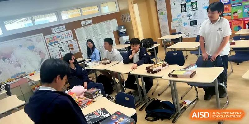 Students working in small groups at modular desks during an interactive lesson in a classroom at HD Beijing School.