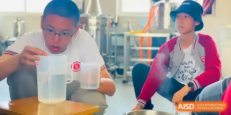 A student focuses on a science experiment involving liquids and containers in a lab at Qingdao Experimental High School.