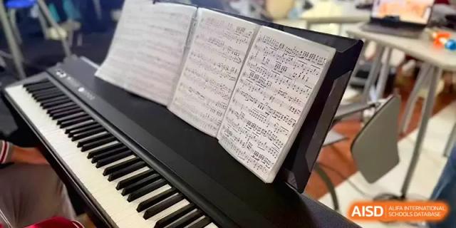 A close-up shot of sheet music resting on a piano stand ready for a music lesson at Qingdao Experimental High School.