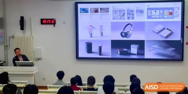 Rear view of students focused on a digital presentation about consumer electronics at Qingdao Experimental High School.