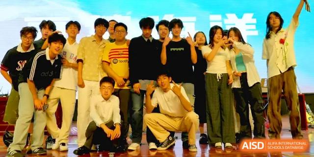 A group of male students pose together for a casual team photo on a court at Qingdao Experimental High School.
