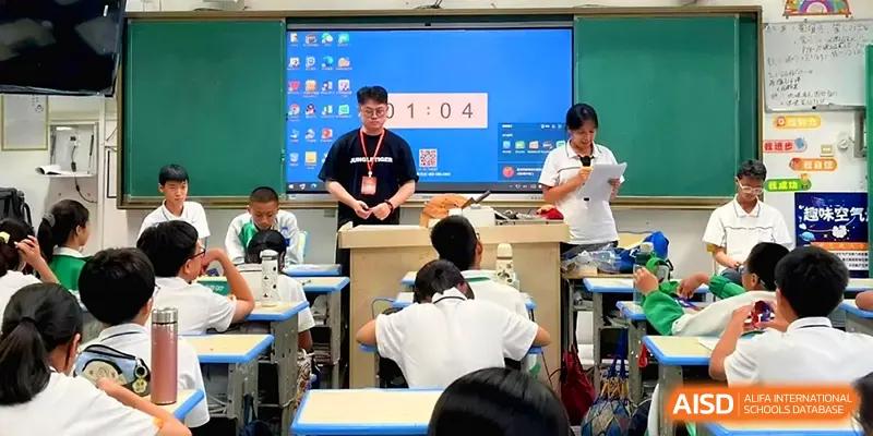 A teacher leads a classroom session with a large digital timer displayed on the screen for students at Quanzhou No. 5 Middle School.