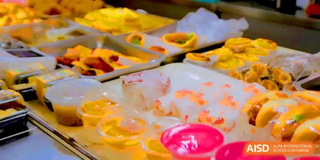 A colorful variety of gelatin desserts and sweet treats displayed in the student canteen at Quanzhou No. 5 Middle School.