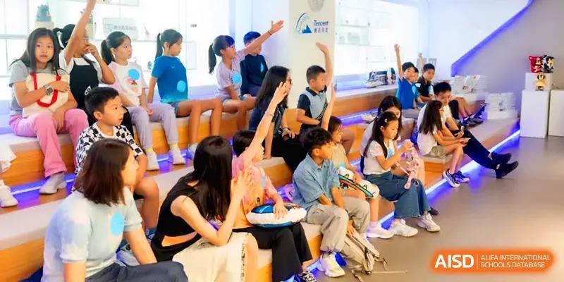 Children sit together in a modern learning space while participating in a group discussion at Shenzhen Mingwan School.