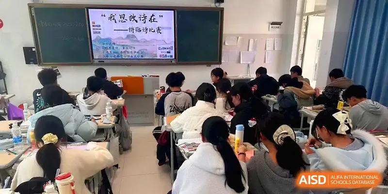 A classroom of students listens attentively to a presentation displayed on a large screen at The Guandu Experimental School Affiliated To Shanghai Normal University.