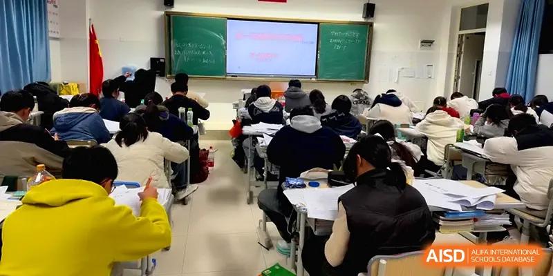 Students sit at their desks facing a digital whiteboard during a structured lesson at The Guandu Experimental School Affiliated To Shanghai Normal University.