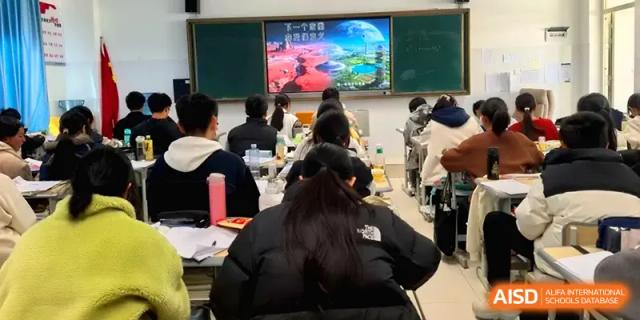 Students sit in a classroom watching a colorful educational presentation on a large front screen at The Guandu Experimental School Affiliated To Shanghai Normal University.