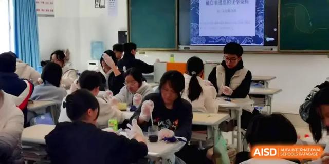 Students wear protective gloves while conducting a hands-on science experiment in a classroom at The Guandu Experimental School Affiliated To Shanghai Normal University.