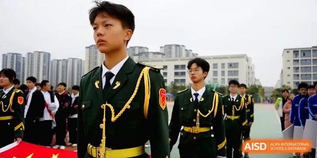 A young student in a military-style uniform stands at attention during an event at The Guandu Experimental School Affiliated To Shanghai Normal University.