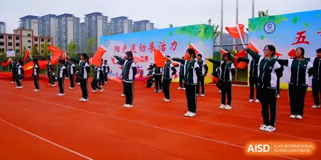 Students perform a group exercise routine on a red track during a sports day at The Guandu Experimental School Affiliated To Shanghai Normal University.