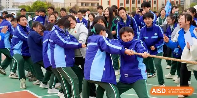 Students participate in a high-energy tug-of-war competition on the school field at The Guandu Experimental School Affiliated To Shanghai Normal University.