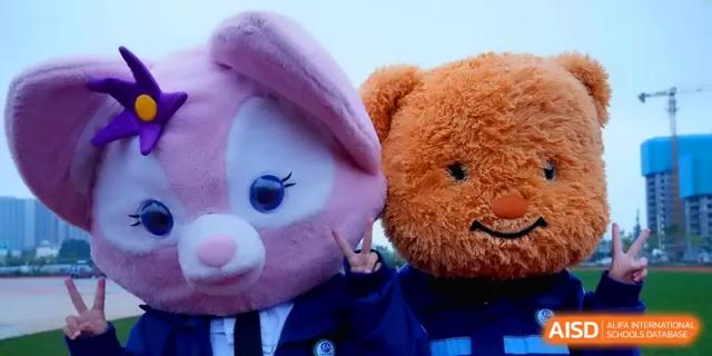 Two people in large rabbit and bear mascot costumes pose for a photo at The Guandu Experimental School Affiliated To Shanghai Normal University.