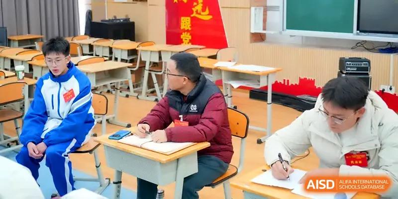 A staff member focuses on writing during a professional development session in a bright classroom at The Middle School Affiliated to Sichuan University.