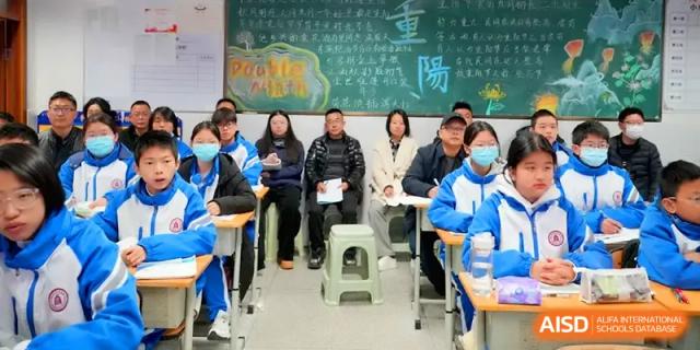 Staff and students sit in a classroom for a collaborative meeting or shared learning experience at The Middle School Affiliated to Sichuan University.