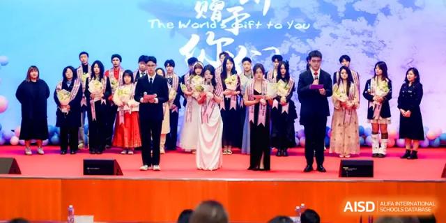 A large group of students in formal attire poses together on stage during a grand school performance or ceremony at The Middle School Affiliated to Sichuan University.