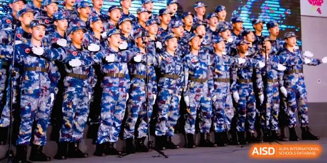 A group of students in blue camouflage uniforms stands in formation during a military-style training exercise at The Middle School Affiliated to Sichuan University.