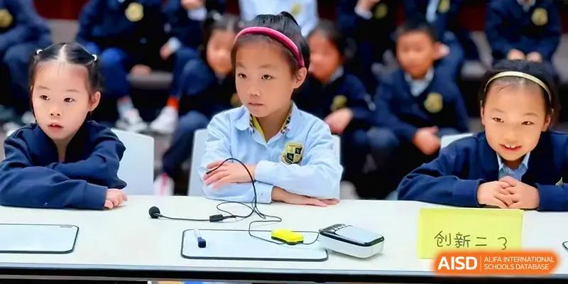 A student sits attentively at a desk with science equipment during a classroom activity at Xiwai International School.
