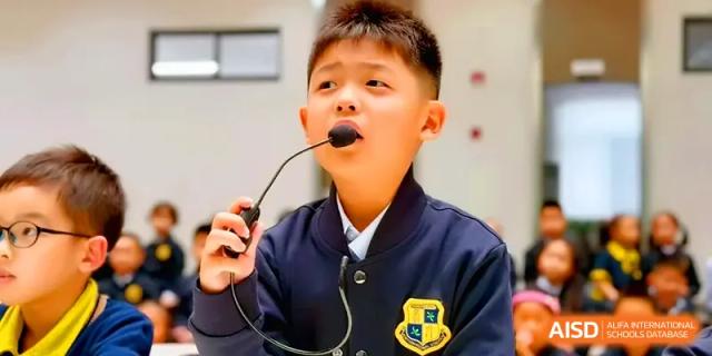 A young student speaks confidently into a desktop microphone during a presentation at Xiwai International School.