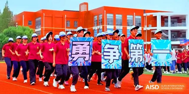 Students in blue caps run across an outdoor track while holding up large blue and white placards at Xiwai International School.