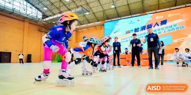 Young students wearing helmets and protective gear participate in an indoor roller skating race at Xiwai International School.
