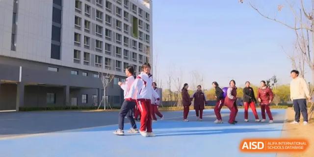 Students in athletic wear enjoy a sunny day of team sports and group activities on the blue courts at Xuzhou No.1 Middle School.