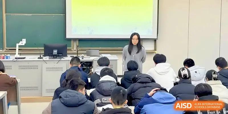 A teacher stands at the front of a lecture hall addressing a large group of attentive students at Yangzhou High School of Jiangsu Province.