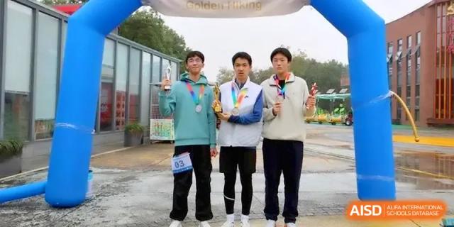 Three student athletes proudly display their medals and trophies outdoors at Yangzhou High School of Jiangsu Province.