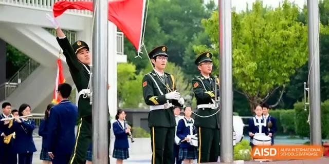 Uniformed student guards participate in a formal flag-raising ceremony on the campus grounds at Yangzhou High School of Jiangsu Province.