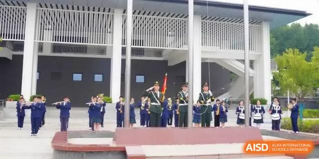 Student honor guards in military-style uniforms stand at attention during a ceremony at Yangzhou High School of Jiangsu Province.