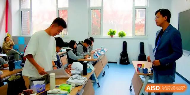 Students sit at organized desks in a bright, modern classroom, focused on their individual study materials and notes at Beijing Xinxuedao Linchuan School.