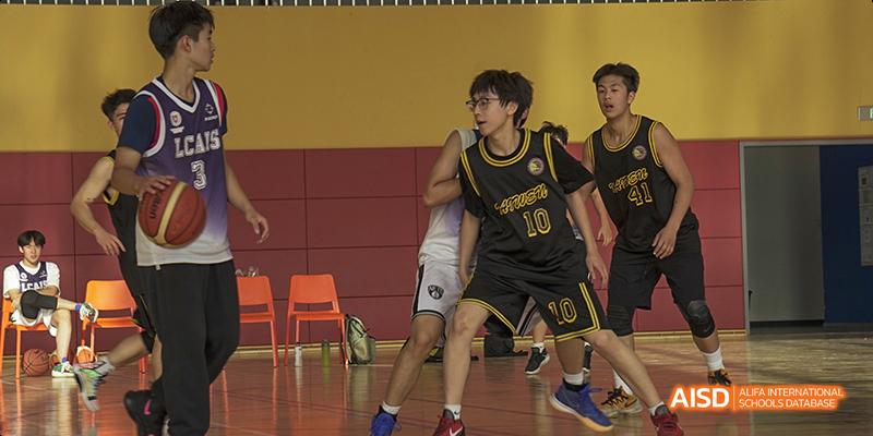 Students at Beijing Limai (International) School play a basketball game.