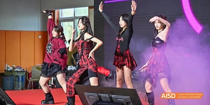 Students from Beijing Limai (International) School perform on a stage.