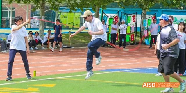 A student at Beijing Limai (International) School jumps during a running activity.