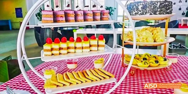 A dessert table with cakes and tarts at Beijing Limai (International) School.