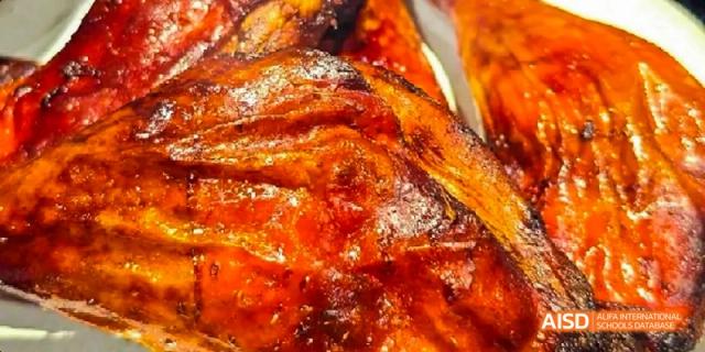A close-up shot of a roasted duck dish served at Beijing Limai (International) School.