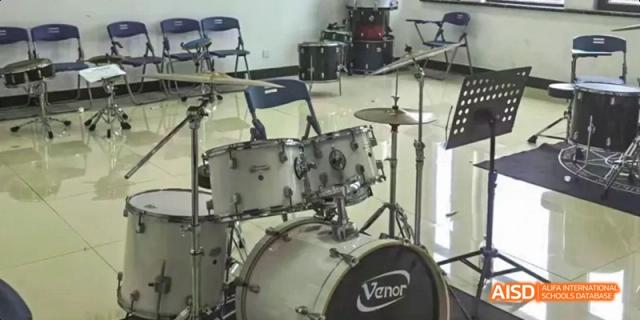 A close-up of a drum kit set-up, ready for music lessons or a performance, at Maple Leaf International School Chongqing.
