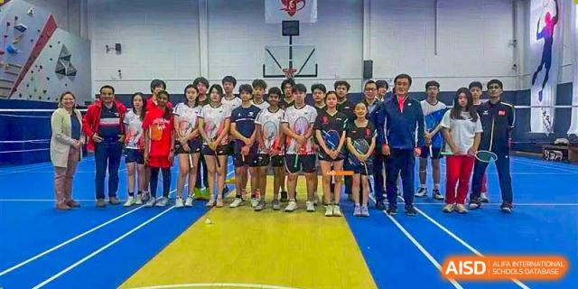 Two Canadian International School of Beijing sports teams and their coaches stand together for a group photo on an indoor court.