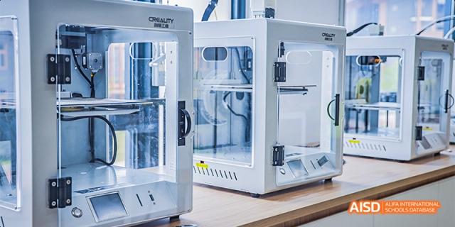 A close-up of a modern 3D printer in a technology or design classroom at Fettes College Guangzhou.
