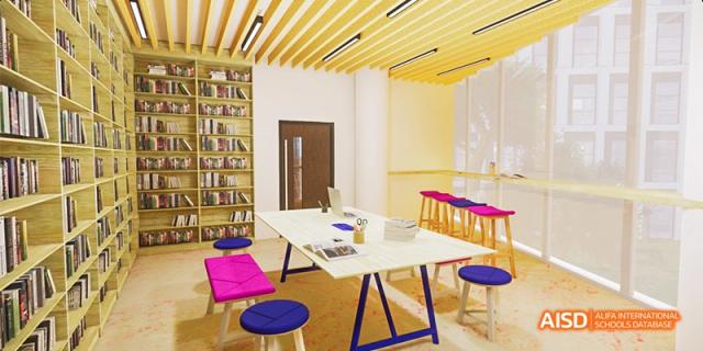 A modern, brightly lit student collaboration space at Fettes College Guangzhou with white tables and vibrant pink and blue stools.