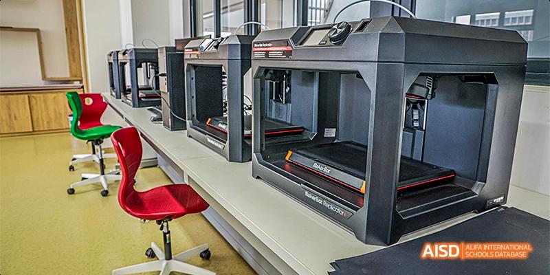 A close-up of advanced 3D printing equipment or heavy-duty machinery in a workshop or laboratory at Fettes College Guangzhou.