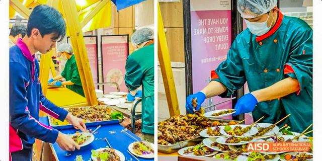 A staff member at Fettes College Guangzhou serving a plate of delicious grilled food, likely from an international food market or special dining event.